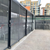 black steel bike shelter with two tier racks and mesh sliding gates installed