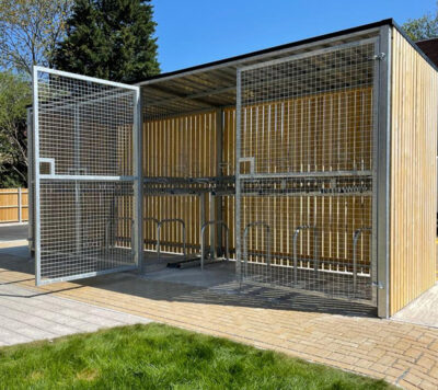 wooden bike shelter with swing mesh gate outside