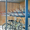 two tier wooden bike shelter with red handles and bikes securely parked