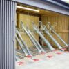 semi vertical gas assisted two tier bike rack with galvanised handles inside a bike shelter