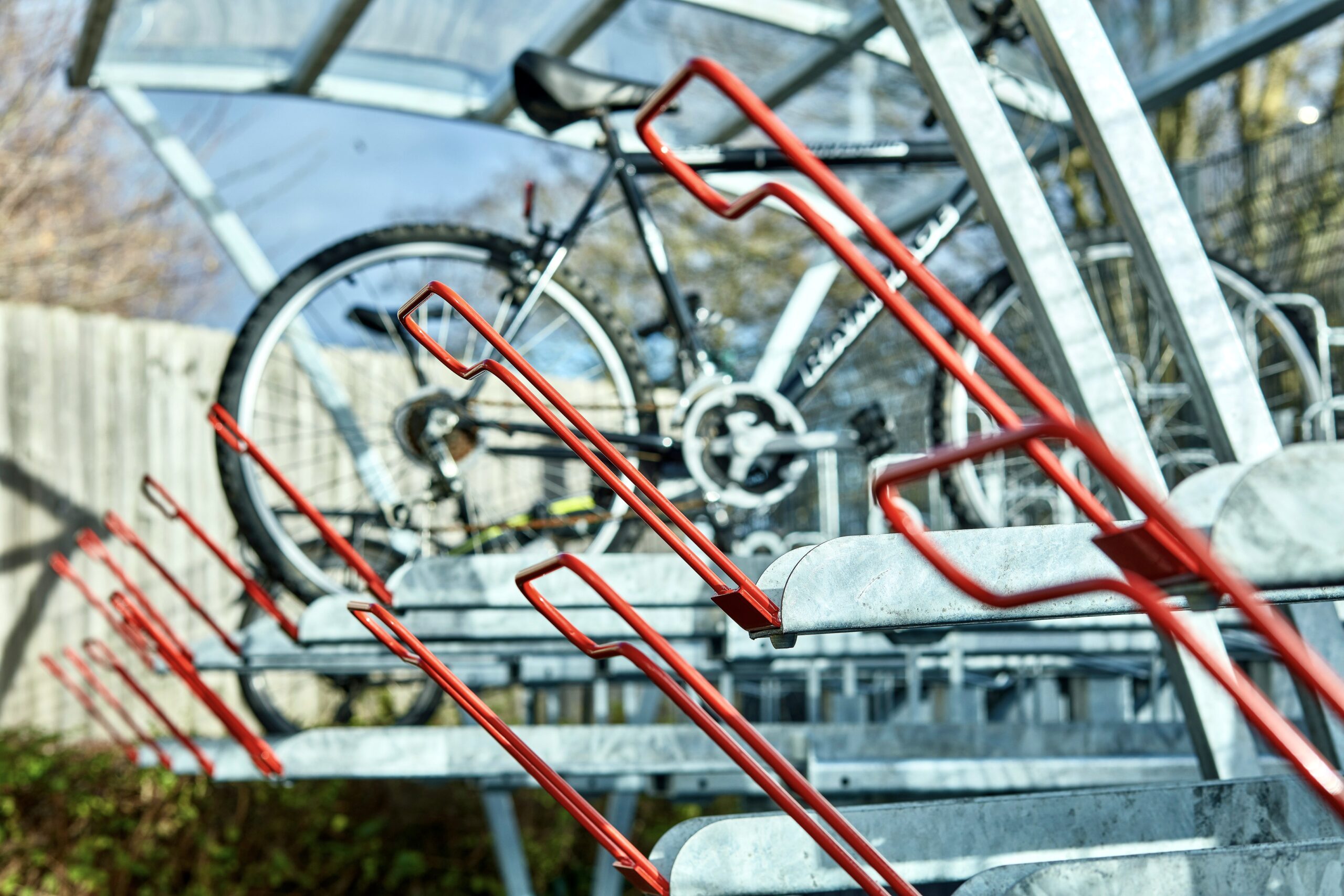 two tier bike rack with red galvanised handles in outdoor Chelsea shelter