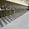 two tier bike rack with blue galvanised handles in commercial building