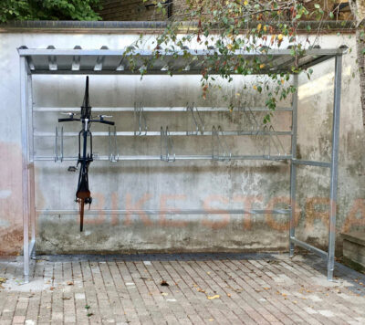 bike shelter outside with a bike hanging vertically