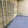 solo vertical bike racks against a brick wall underground