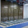 Perforated mesh fencing installed in an underground cycle storage facility with single tier cycle racks installed