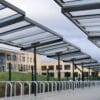 Metal and glass cycling shelter outside of a school