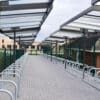 Metal and glass cycling shelter outside of a school