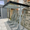 cycling shelter with metal frames and glass roof