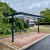 metal and glass cycle shelter with sheffield bike stands installed