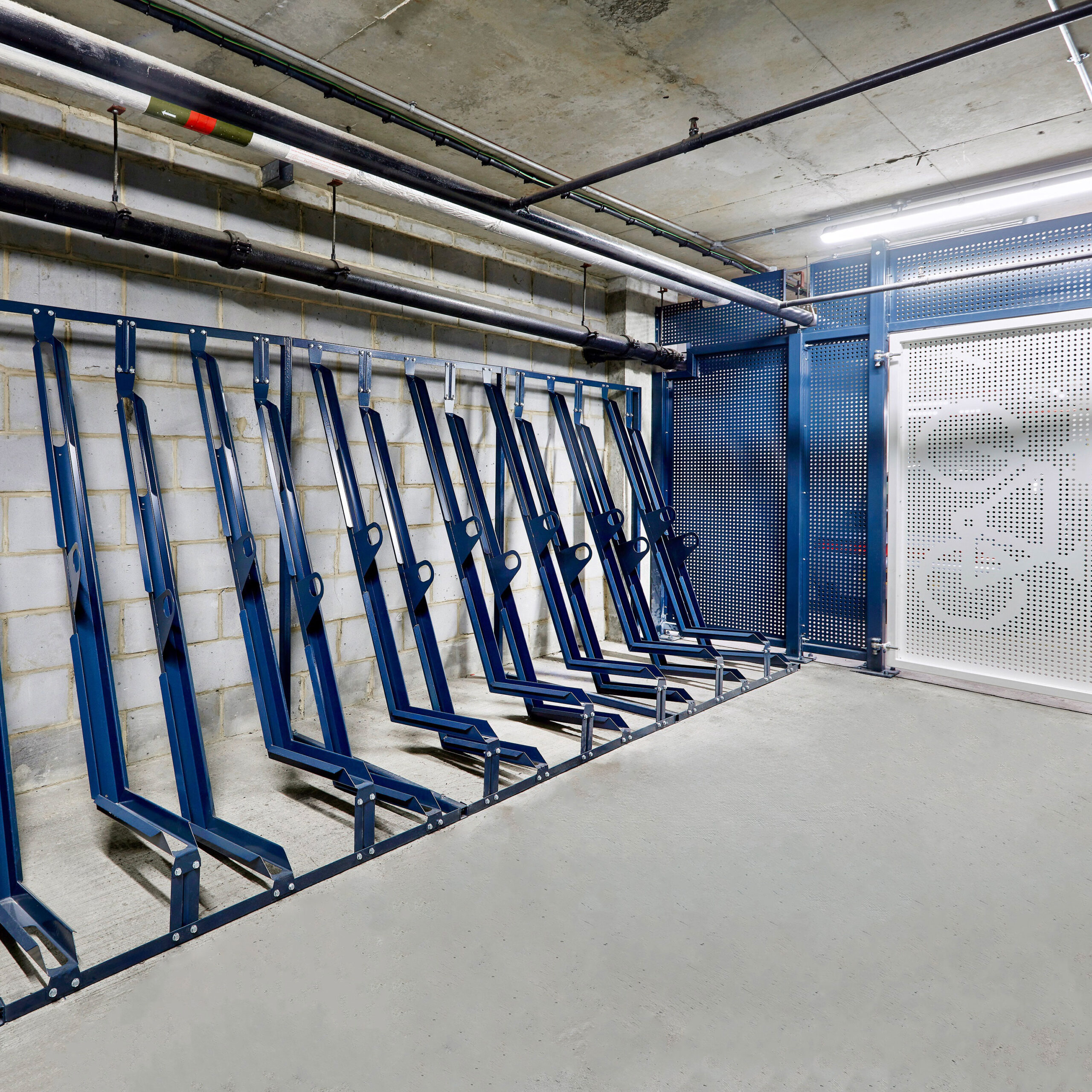 blue semi vertical bike racks in underground bike storage