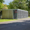 a large wooden cycle shelter with metal fencing