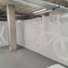 White perforated security mesh fencing with logo of bike