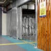 Perforated Mesh Fencing installed in an underground cycling storage facility with a sign showing the cycle storage and timber slat fencing