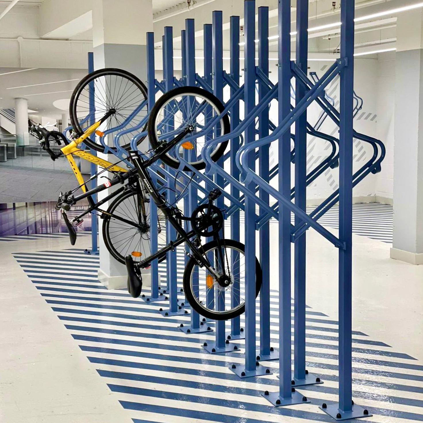 bikes on premium solo vertical bike racks in a commercial building