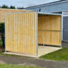 wooden cycle shelter with sheffield stands outside a property