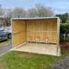 wooden cycle shelter with sheffield stands outside a property