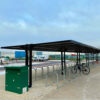 big bird gullwing shelter installed in a carpark with toastracks