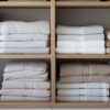 The linen cupboard shelves in this eco friendly storage solution are neatly folded and organised.