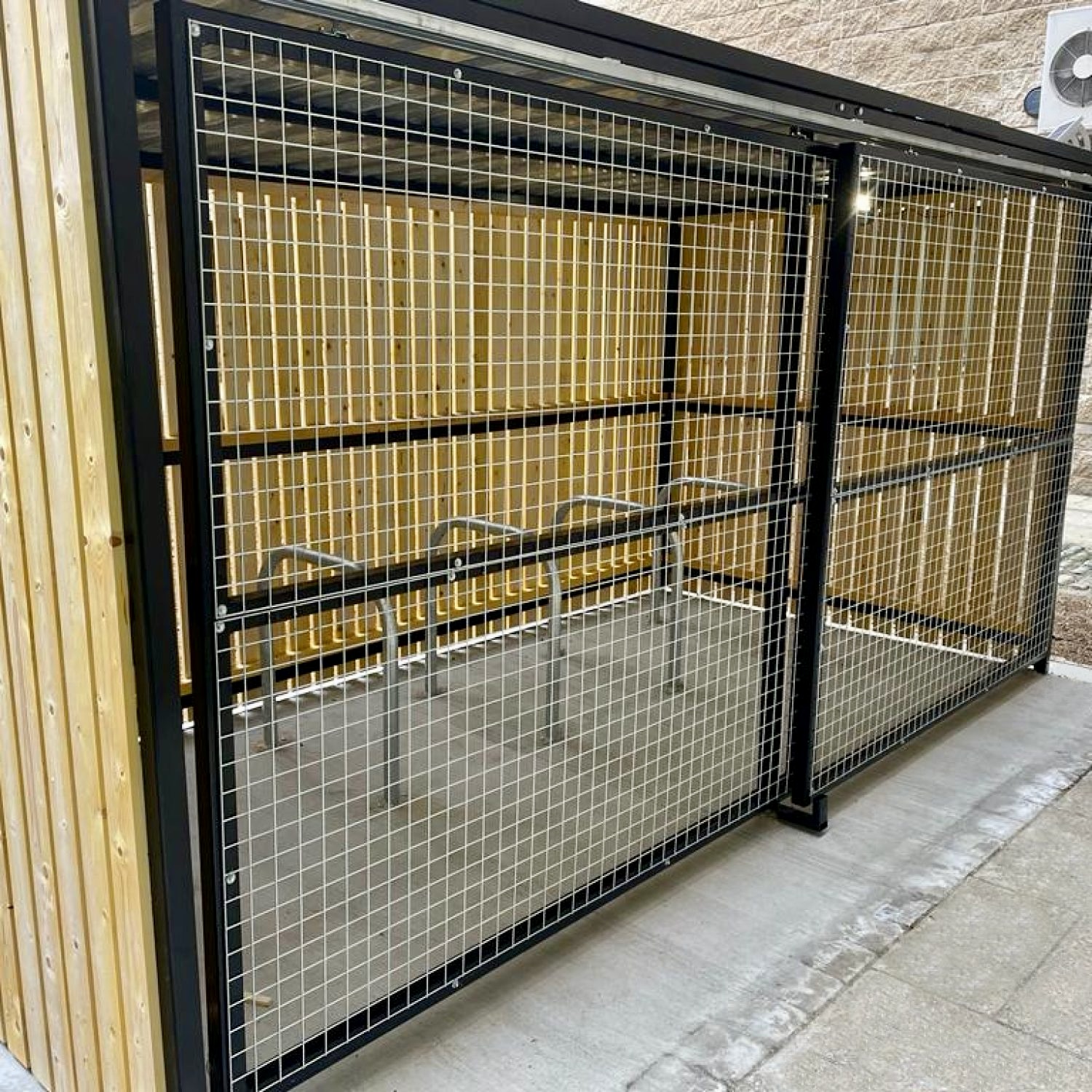 close up of fire retardant wooden bike shelter with mesh fencing