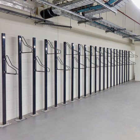 row of solo vertical bike racks stored in underground cycle storage
