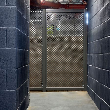 Perforated Mesh Fencing with swing door installed in an internal cycle storage facility