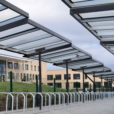 Metal and glass cycling shelter outside of a school