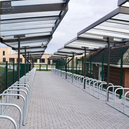 Metal and glass cycling shelter outside of a school