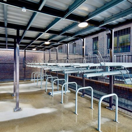two tier cycle racks and bike stands installed within a bike shelter