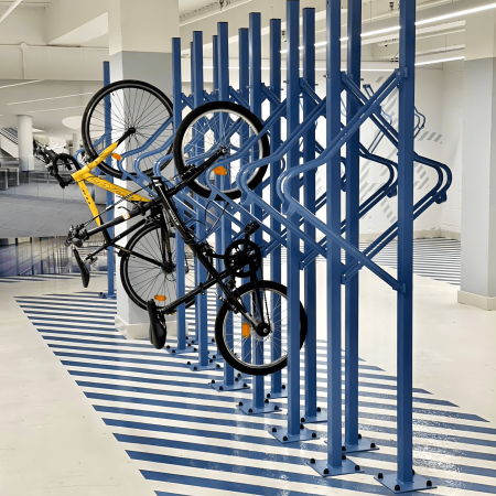 Premium Solo Vertical Bike Rack in RAL colour blue with two bikes securely hung